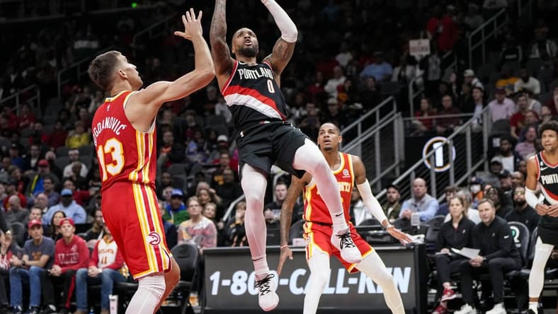 Mar 3, 2023; Atlanta, Georgia, USA; Portland Trail Blazers guard Damian Lillard (0) shoots over Atlanta Hawks guard Bogdan Bogdanovic (13) during the first half at State Farm Arena. Mandatory Credit: Dale Zanine-USA TODAY Sports