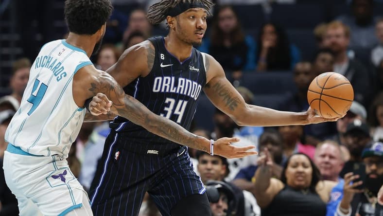 Mar 3, 2023; Charlotte, North Carolina, USA; Orlando Magic center Wendell Carter Jr. (34) looks to pass against Charlotte Hornets center Nick Richards (4) during the second half at Spectrum Center. Mandatory Credit: Nell Redmond-USA TODAY Sports