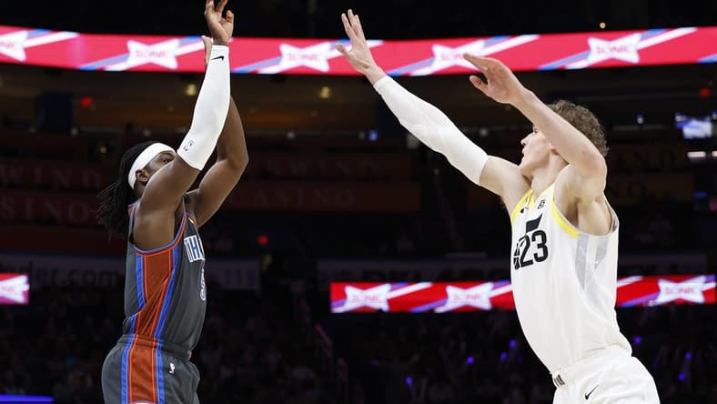 Mar 3, 2023; Oklahoma City, Oklahoma, USA; Oklahoma City Thunder guard Luguentz Dort (5) shoots a three point basket against Utah Jazz forward Lauri Markkanen (23) during the first quarter at Paycom Center. Mandatory Credit: Alonzo Adams-USA TODAY Sports
