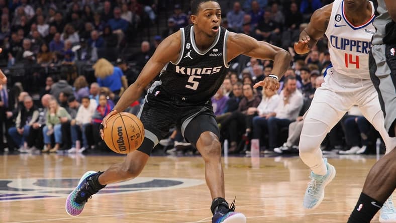 Mar 3, 2023; Sacramento, California, USA; Sacramento Kings point guard De'Aaron Fox (5) drives in against Los Angeles Clippers shooting guard Terance Mann (14) during the second quarter at Golden 1 Center. Mandatory Credit: Kelley L Cox-USA TODAY Sports