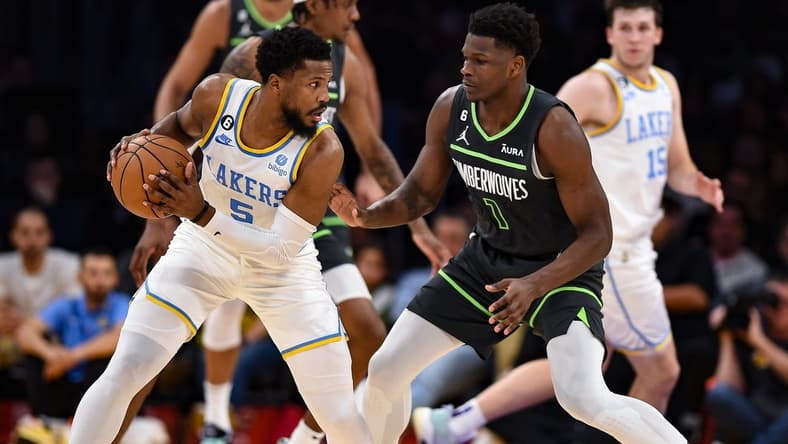 Mar 3, 2023; Los Angeles, California, USA; Los Angeles Lakers guard Malik Beasley (5) handles the ball against Minnesota Timberwolves guard Anthony Edwards (1) during the second quarter at Crypto.com Arena. Mandatory Credit: Jonathan Hui-USA TODAY Sports