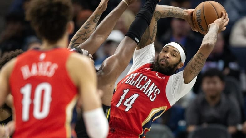 Mar 3, 2023; San Francisco, California, USA; New Orleans Pelicans forward Brandon Ingram (14) looks for a teammate to pass to as he is pressured by Golden State Warriors forward Kevon Looney during the third quarter at Chase Center. Mandatory Credit: D. Ross Cameron-USA TODAY Sports