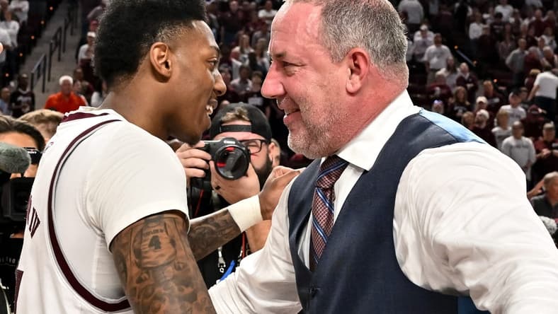 Mar 4, 2023; College Station, Texas, USA; Texas A&M Aggies head coach Buzz Williams and guard Wade Taylor IV (4) embrace after defeating the Alabama Crimson Tide at Reed Arena. Mandatory Credit: Maria Lysaker-USA TODAY Sports