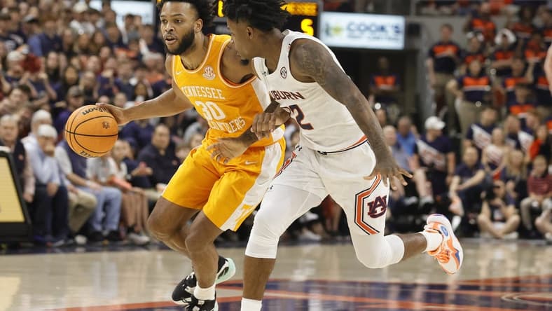 Mar 4, 2023; Auburn, Alabama, USA;  Tennessee Volunteers guard Josiah-Jordan James (30) drives in against Auburn Tigers guard Zep Jagainstper (12) during the first half at Neville Arena. Mandatory Credit: John Reed-USA TODAY Sports