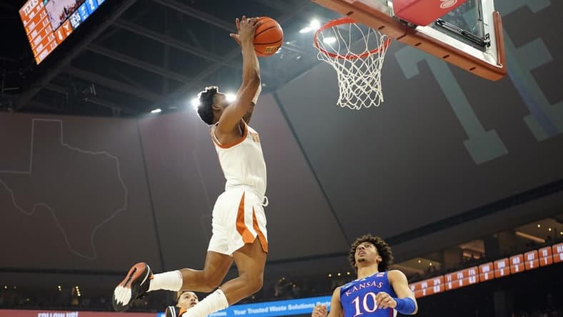 Mar 4, 2023; Austin, Texas, USA; Texas Longhorns guard Tyrese Hunter (4) dunks over Kansas Jayhawks forward Jalen Wilson (10) during the first half at Moody Center. Mandatory Credit: Scott Wachter-USA TODAY Sports