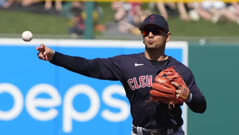 Mar 4, 2023; Mesa, Arizona, USA; Cleveland Guardians second baseman Andres Gimenez (0) makes the play for an out against the Oakland Athletics in the first inning at Hohokam Stadium. Mandatory Credit: Rick Scuteri-USA TODAY Sports