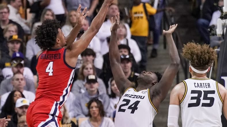 Mar 4, 2023; Columbia, Missouri, USA; Mississippi Rebels forward Jaemyn Brakefield (4) shoots as Missouri Tigers guard Kobe Brown (24) defends during the first half at Mizzou Arena. Mandatory Credit: Denny Medley-USA TODAY Sports