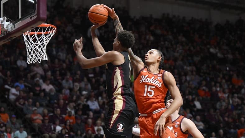 Mar 4, 2023; Blacksburg, Virginia, USA; Virginia Tech Hokies center Lynn Kidd (15) blocks a shot by Florida State Seminoles forward Baba Miller (11) in the first half at Cassell Coliseum. Mandatory Credit: Lee Luther Jr.-USA TODAY Sports