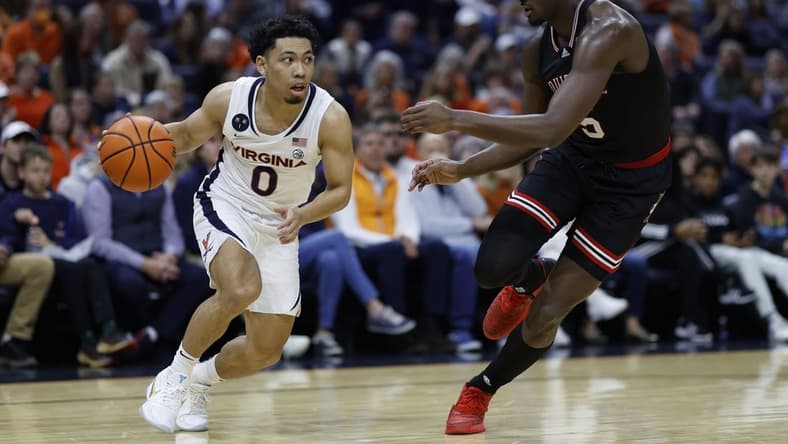 Mar 4, 2023; Charlottesville, Virginia, USA; Virginia Cavaliers guard Kihei Clark (0) drives to the basket as Louisville Cardinals forward Brandon Huntley-Hatfield (5) defends in the second half at John Paul Jones Arena. Mandatory Credit: Geoff Burke-USA TODAY Sports
