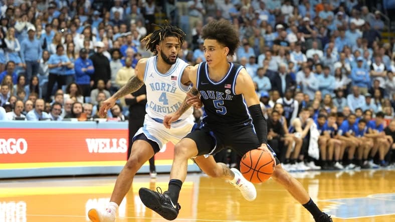 Mar 4, 2023; Chapel Hill, North Carolina, USA;  Duke Blue Devils guard Tyrese Proctor (5) dribbles as North Carolina Tar Heels guard R.J. Davis (4) defends in the first half at Dean E. Smith Center. Mandatory Credit: Bob Donnan-USA TODAY Sports
