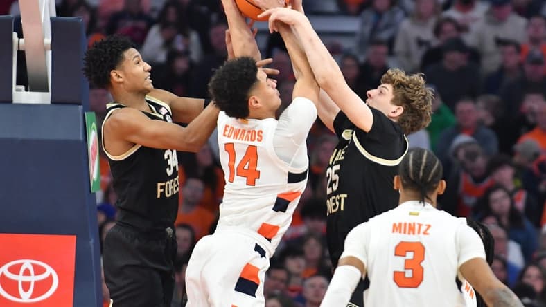 Mar 4, 2023; Syracuse, New York, USA; Syracuse Orange center Jesse Edwards (14) battles Wake Forest Demon Deacons forward Bobi Klintman (34) and forward Zach Keller (25) for a rebound in the second half at JMA Wireless Dome. Mandatory Credit: Mark Konezny-USA TODAY Sports