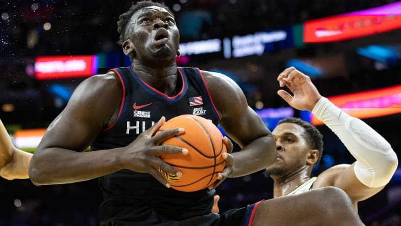Mar 4, 2023; Philadelphia, Pennsylvania, USA; Connecticut Huskies forward Adama Sanogo (21) rebounds the ball in front of Villanova Wildcats forward Eric Dixon (43) during the first half at Wells Fargo Center. Mandatory Credit: Bill Streicher-USA TODAY Sports