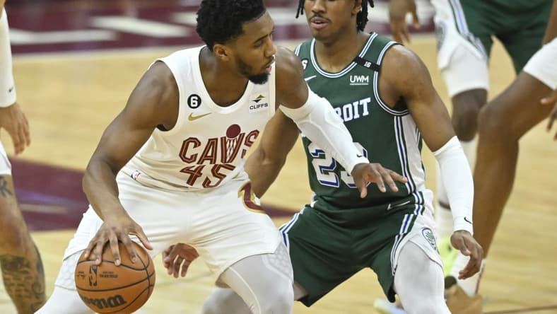 Mar 4, 2023; Cleveland, Ohio, USA; Cleveland Cavaliers guard Donovan Mitchell (45) dribbles beside Detroit Pistons guard Jaden Ivey (23) in the second quarter at Rocket Mortgage FieldHouse. Mandatory Credit: David Richard-USA TODAY Sports