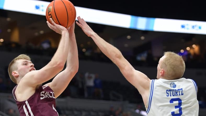 Mar 4, 2023; St. Louis, MO, USA; Southern Illinois Salukis forward Marcus Domask (1) shoots over Drake Bulldogs guard Garrett Sturtz (3) during the second half at Enterprise Center. Mandatory Credit: Ron Johnson-USA TODAY Sports