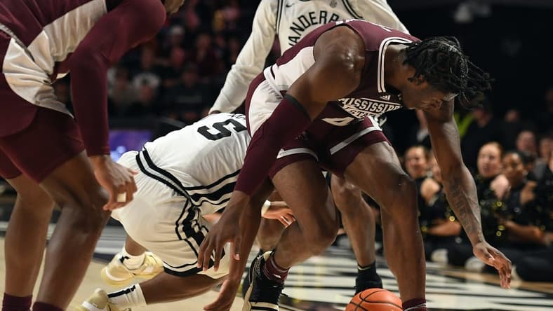 Mar 4, 2023; Nashville, Tennessee, USA; Mississippi State Bulldogs guard Cameron Matthews (4) loses the ball to Vanderbilt Commodores guard Ezra Manjon (5) during the first half at Memorial Gymnasium. Mandatory Credit: Christopher Hanewinckel-USA TODAY Sports
