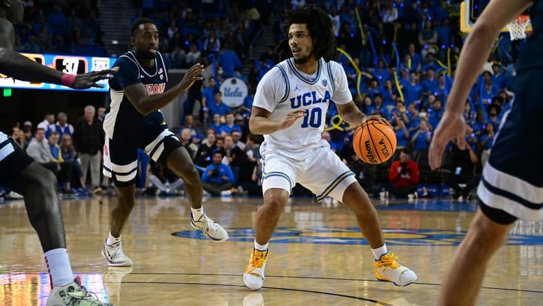 Mar 4, 2023; Los Angeles, California, USA;  UCLA Bruins guard Tyger Campbell (10) controls the ball as Arizona Wildcats guard Courtney Ramey (0) defends during the second half at Pauley Pavilion presented by Wescom. Mandatory Credit: Richard Mackson-USA TODAY Sports