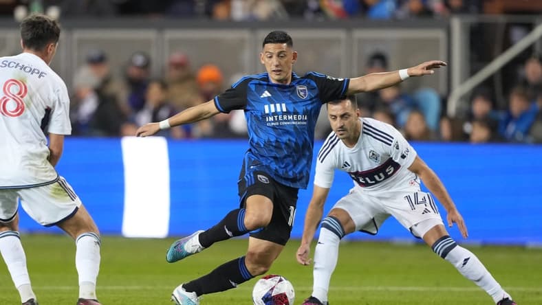 Mar 4, 2023; San Jose, California, USA; San Jose Earthquakes forward Cristian Espinoza (10) dribbles against Vancouver Whitecaps midfielder Alessandro Schopf (8) and defender Lu s Martins (14) during the first half at PayPal Park. Mandatory Credit: Darren Yamashita-USA TODAY Sports