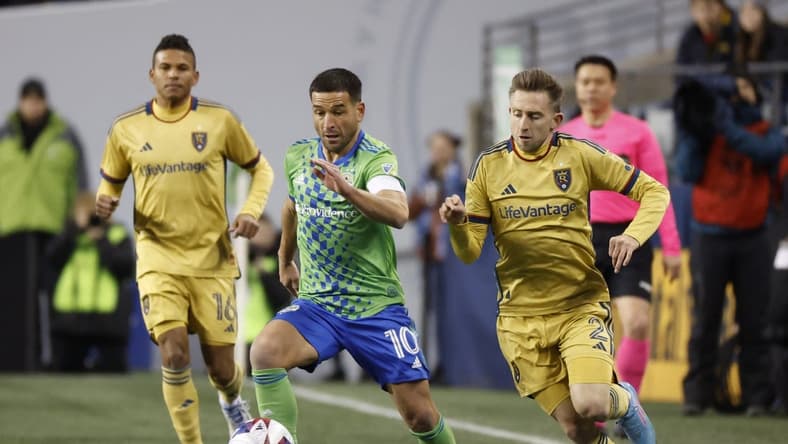 Mar 4, 2023; Seattle, Washington, USA; Seattle Sounders midfielder Nicolas Lodeiro (10) and Real Salt Lake defender Andrew Brody (2) battle for the ball during the first half at Lumen Field. Mandatory Credit: Joe Nicholson-USA TODAY Sports