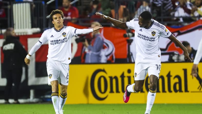 Mar 4, 2023; Frisco, Texas, USA;  Los Angeles Galaxy midfielder Riqui Puig (6) celebrates with Los Angeles Galaxy defender Kelvin Leerdam (18) after scoring a goal during the first half against FC Dallas at Toyota Stadium. Mandatory Credit: Kevin Jairaj-USA TODAY Sports