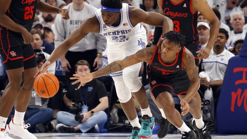 Mar 5, 2023; Memphis, Tennessee, USA; Memphis Tigers forward Malcolm Dandridge (23) and Houston Cougars guard Marcus Sasser (0) battle for a loose ball during the first half at FedExForum. Mandatory Credit: Petre Thomas-USA TODAY Sports