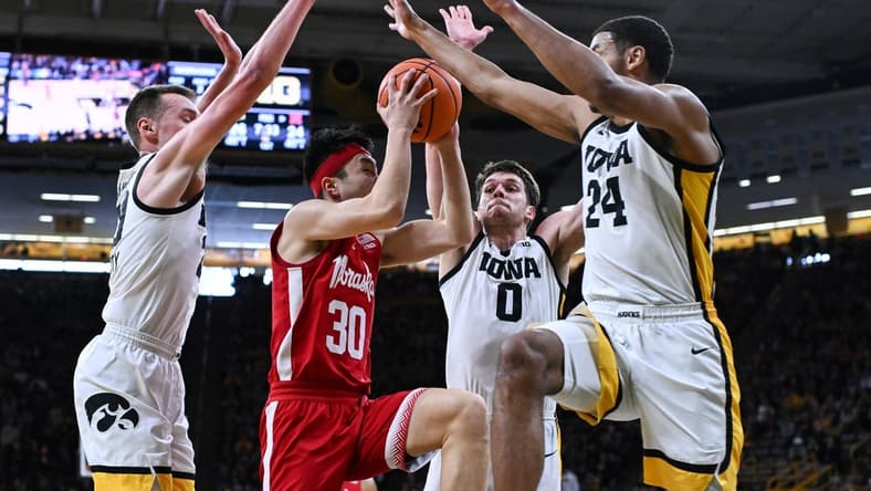 Mar 5, 2023; Iowa City, Iowa, USA; Nebraska Cornhuskers guard Keisei Tominaga (30) goes to the basket as Iowa Hawkeyes forward Kris Murray (24), forward Filip Rebraca (0) and forward Payton Sandfort (left) defend during the first half at Carver-Hawkeye Arena. Mandatory Credit: Jeffrey Becker-USA TODAY Sports