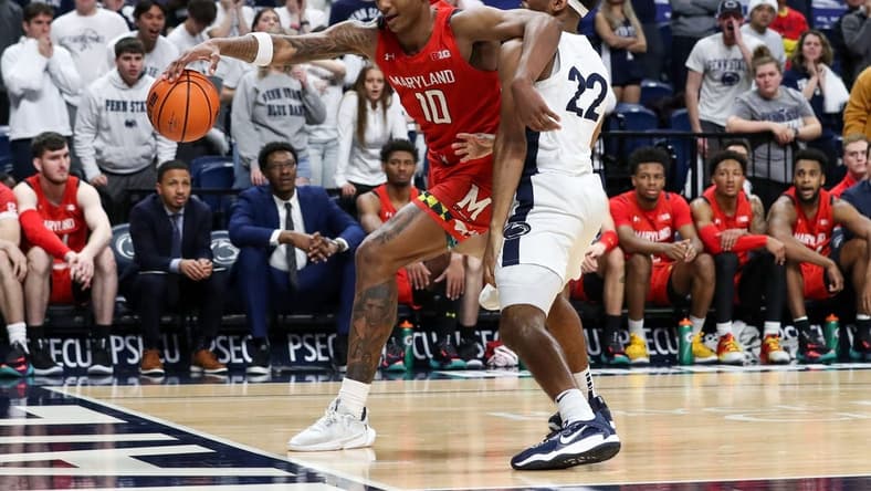 Mar 5, 2023; University Park, Pennsylvania, USA; Maryland Terrapins forward Julian Reese (10) tries to keep the ball in bounds as Penn State Nittany Lions guard Jalen Pickett (22) defends during the second half at Bryce Jordan Center. Mandatory Credit: Matthew OHaren-USA TODAY Sports