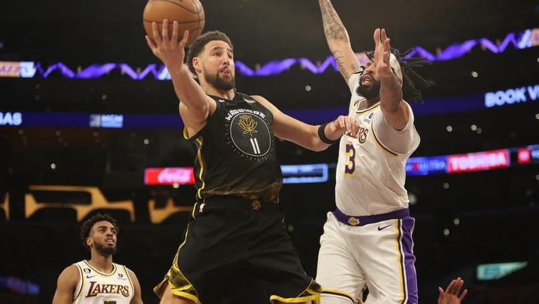 Mar 5, 2023; Los Angeles, California, USA; Golden State Warriors guard Klay Thompson (11) goes to the basket against Los Angeles Lakers forward Anthony Davis (3) during the first quarter at Crypto.com Arena. Mandatory Credit: Kiyoshi Mio-USA TODAY Sports