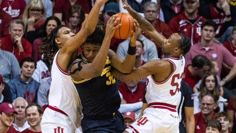 Mar 5, 2023; Bloomington, Indiana, USA; Michigan Wolverines forward Tarris Reed Jr. (32) looks to pass the ball while Indiana Hoosiers forward Malik Reneau (5) and guard Tamar Bates (53) defend in the first half at Simon Skjodt Assembly Hall. Mandatory Credit: Trevor Ruszkowski-USA TODAY Sports