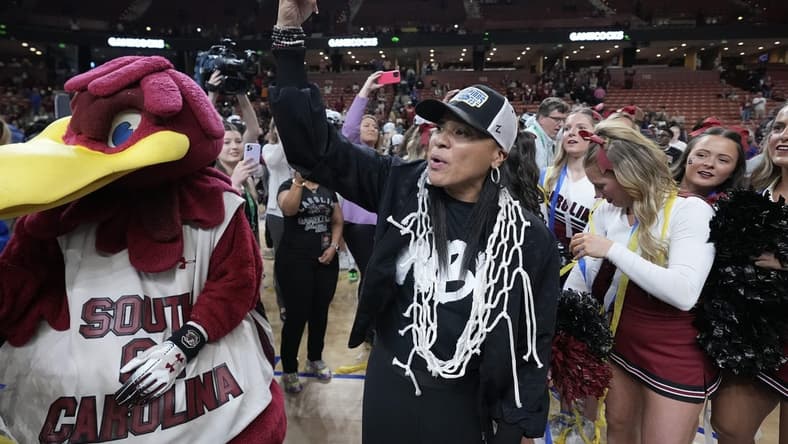 Mar 5, 2023; Greenville, SC, USA; South Carolina Gamecocks head coach Dawn Staley wears the net rounder neck and flashes a number on to the crowd after winning the SEC Championship at Bon Secours Wellness Arena. Mandatory Credit: David Yeazell-USA TODAY Sports