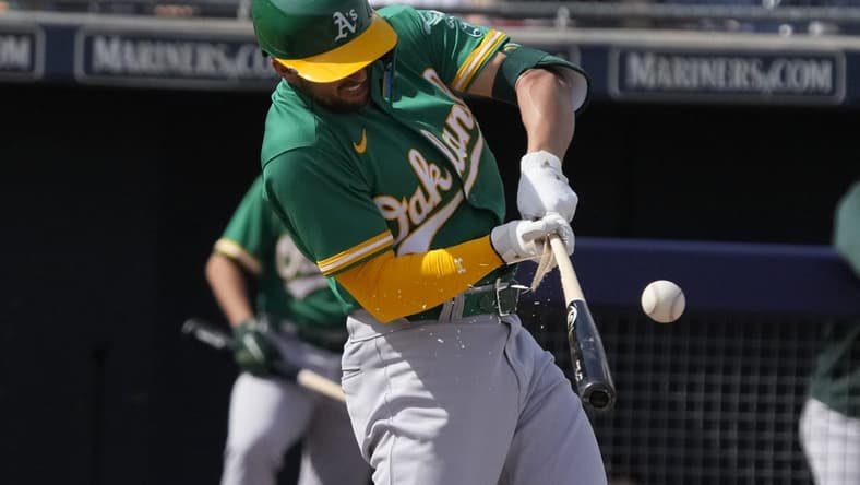 Mar 5, 2023; Peoria, Arizona, USA; Oakland Athletics third baseman Kevin Smith (4) breaks his bat against the San Diego Padres in the third inning at Peoria Sports Complex. Mandatory Credit: Rick Scuteri-USA TODAY Sports