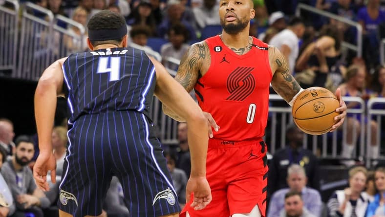 Mar 5, 2023; Orlando, Florida, USA; Portland Trail Blazers guard Damian Lillard (0) brings the ball up court in front of Orlando Magic guard Jalen Suggs (4) during the first quarter at Amway Center. Mandatory Credit: Mike Watters-USA TODAY Sports