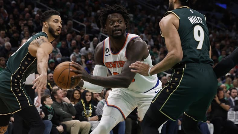Mar 5, 2023; Boston, Massachusetts, USA; New York Knicks forward Julius Randle (30) looks for an opening between Boston Celtics guard Derrick White (9) and forward Jayson Tatum (0) during the first quarter at TD Garden. Mandatory Credit: Winslow Townson-USA TODAY Sports