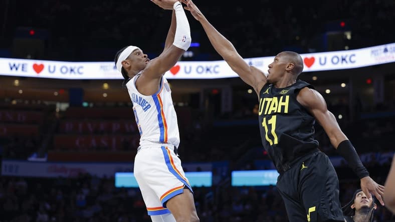 Mar 5, 2023; Oklahoma City, Oklahoma, USA; Oklahoma City Thunder guard Shai Gilgeous-Alexander (2) shoots as Utah Jazz guard Kris Dunn (11) defends the shot during the second quarter at Paycom Center. Mandatory Credit: Alonzo Adams-USA TODAY Sports