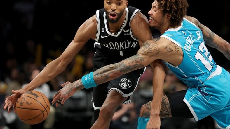 Mar 5, 2023; Brooklyn, New York, USA; Brooklyn Nets forward Mikal Bridges (1) drives to the basket against Charlotte Hornets guard Kelly Oubre Jr. (12) during the fourth quarter at Barclays Center. Mandatory Credit: Brad Penner-USA TODAY Sports