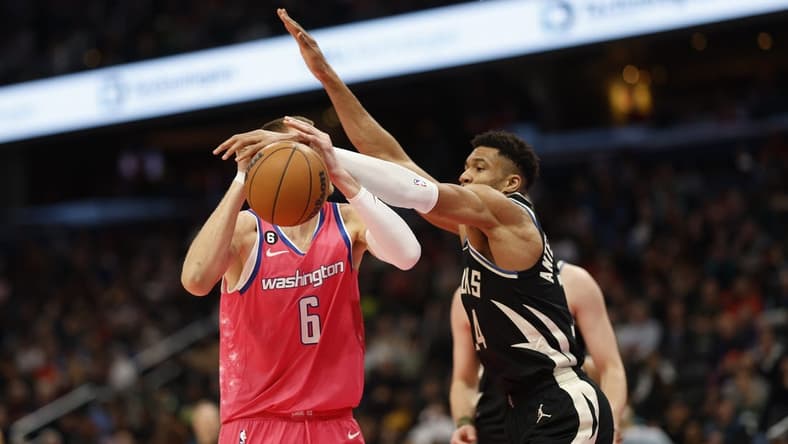 Mar 5, 2023; Washington, District of Columbia, USA; Milwaukee Bucks forward Giannis Antetokounmpo (34) knocks the ball from Washington Wizards center Kristaps Porzingis (6) in the second quarter at Capital One Arena. Mandatory Credit: Geoff Burke-USA TODAY Sports