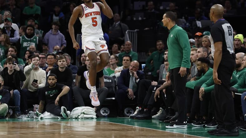 Mar 5, 2023; Boston, Massachusetts, USA; New York Knicks guard Immanuel Quickley (5) celebrates after a basket in front of the Boston Celtics bench during the overtime period at TD Garden. Mandatory Credit: Winslow Townson-USA TODAY Sports