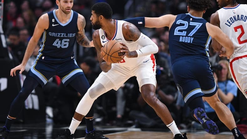 Mar 5, 2023; Los Angeles, California, USA; LA Clippers forward Paul George (13) looks to pass the ball against Memphis Grizzlies guard John Konchar (46) and forward David Roddy (27) during second quarter at Crypto.com Arena. Mandatory Credit: Jonathan Hui-USA TODAY Sports
