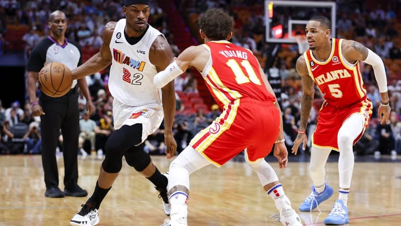 Mar 6, 2023; Miami, Florida, USA; Miami Heat forward Jimmy Butler (22) dribbles the basketball as Atlanta Hawks guard Trae Young (11) defends during the first quarter at Miami-Dade Arena. Mandatory Credit: Sam Navarro-USA TODAY Sports
