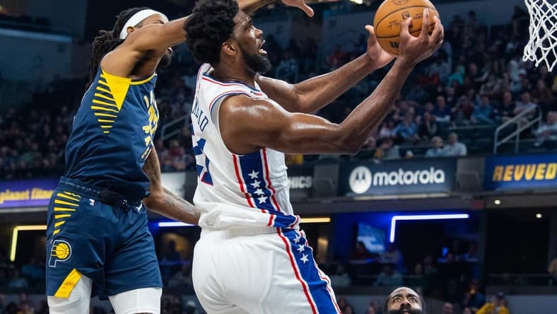 Mar 6, 2023; Indianapolis, Indiana, USA; Philadelphia 76ers center Joel Embiid (21) shoots the ball while Indiana Pacers forward Isaiah Jackson (22) defends in the second quarter at Gainbridge Fieldhouse. Mandatory Credit: Trevor Ruszkowski-USA TODAY Sports