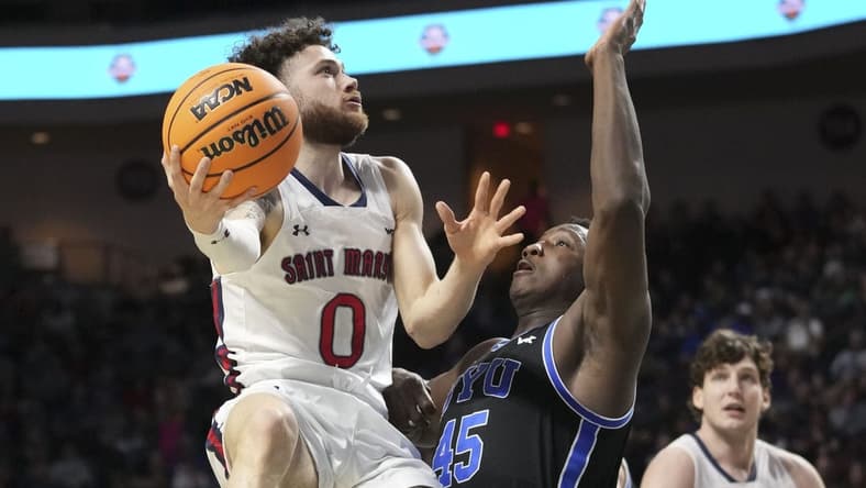 March 6, 2023; Las Vegas, NV, USA; Saint Mary's Gaels guard Logan Johnson (0) shoots the basketball against Brigham Young Cougars forward Fousseyni Traore (45) during the first half in the semifinals of the WCC Basketball Championships at Orleans Arena. Mandatory Credit: Kyle Terada-USA TODAY Sports