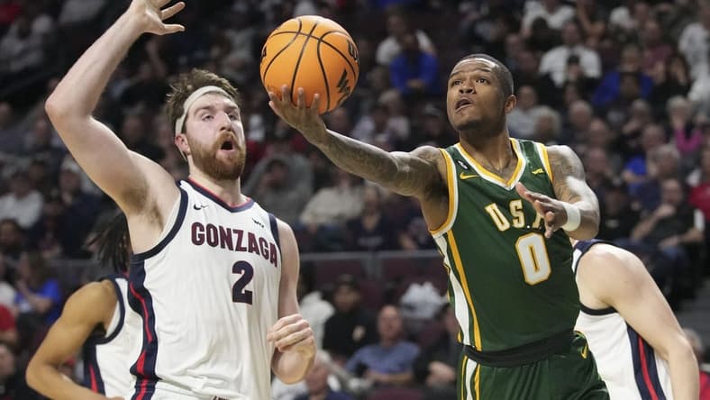March 6, 2023; Las Vegas, NV, USA; San Francisco Dons guard Khalil Shabazz (0) shoots the basketball against Gonzaga Bulldogs forward Drew Timme (2) during the first half in the semifinals of the WCC Basketball Championships at Orleans Arena. Mandatory Credit: Kyle Terada-USA TODAY Sports