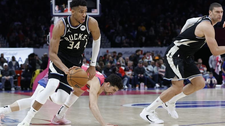 Mar 5, 2023; Washington, District of Columbia, USA; Milwaukee Bucks forward Giannis Antetokounmpo (34) drives to the basket past Washington Wizards forward Deni Avdija (9) at Capital One Arena. Mandatory Credit: Geoff Burke-USA TODAY Sports