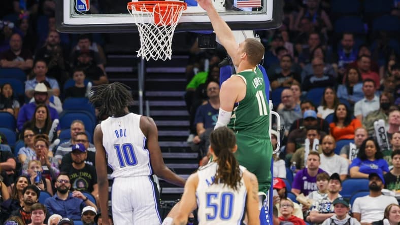 Mar 7, 2023; Orlando, Florida, USA; Milwaukee Bucks center Brook Lopez (11) goes to the basket against Orlando Magic center Bol Bol (10) during the second quarter at Amway Center. Mandatory Credit: Mike Watters-USA TODAY Sports