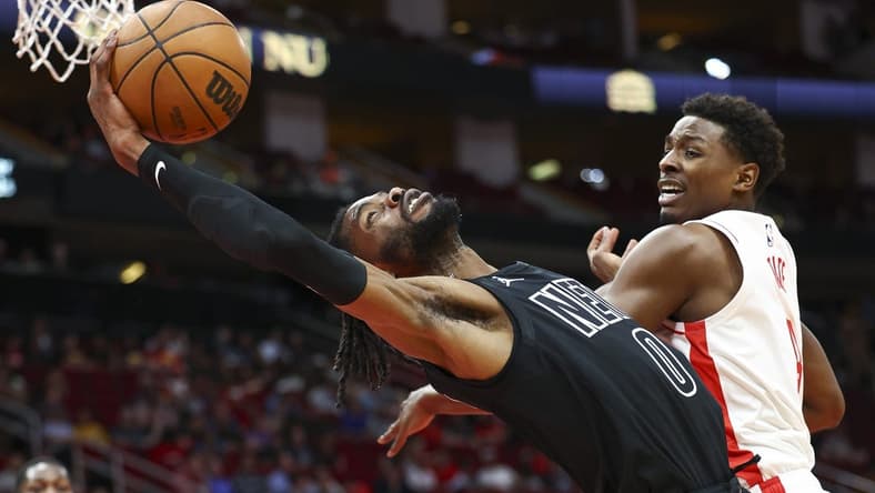 Mar 7, 2023; Houston, Texas, USA; Brooklyn Nets center Nerlens Noel (0) attempts to grab a rebound away from Houston Rockets forward Jae'Sean Tate (8) during the first quarter at Toyota Center. Mandatory Credit: Troy Taormina-USA TODAY Sports