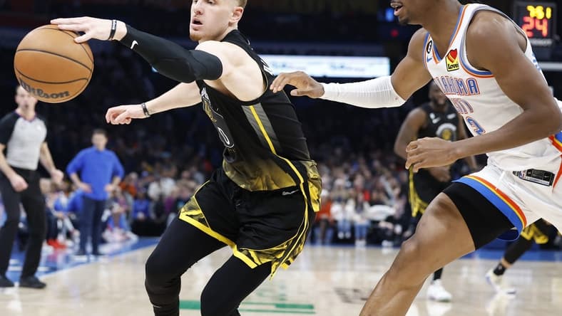 Mar 7, 2023; Oklahoma City, Oklahoma, USA; Golden State Warriors guard Donte DiVincenzo (0) reaches for a loose ball in front of Oklahoma City Thunder guard Shai Gilgeous-Alexander (2) during the second quarter at Paycom Center. Mandatory Credit: Alonzo Adams-USA TODAY Sports