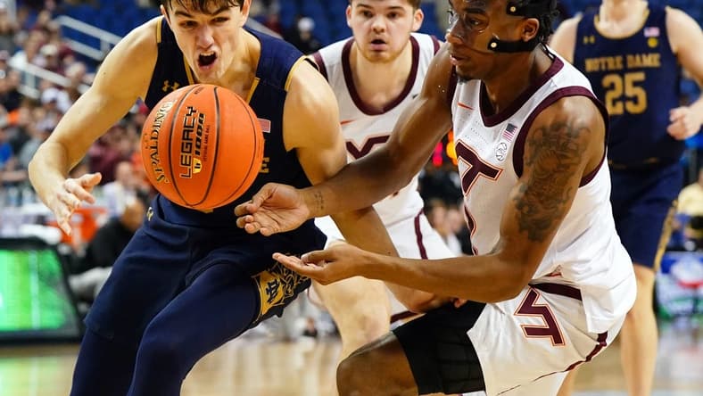 Mar 7, 2023; Greensboro, NC, USA; Notre Dame Fighting Irish guard Cormac Ryan (5) battles for a loose ball with Virginia Tech Hokies guard MJ Collins (2) during the second half of the first round of the ACC tournament at Greensboro Coliseum. Mandatory Credit: John David Mercer-USA TODAY Sports
