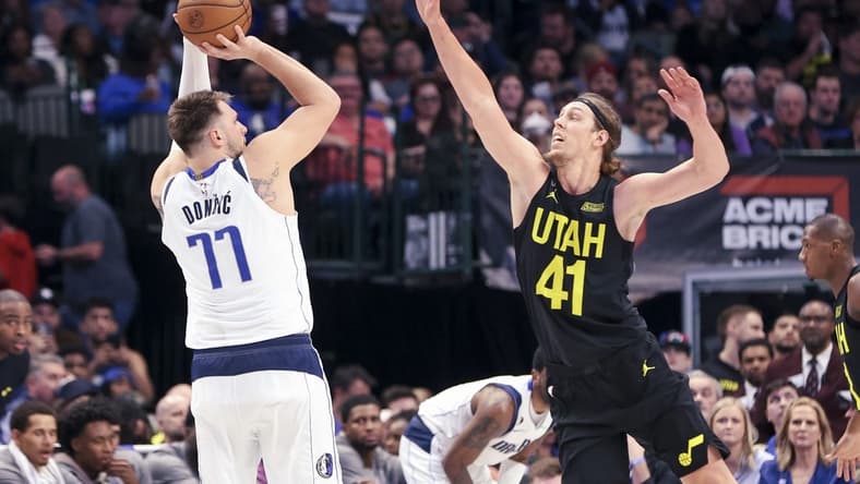 Mar 7, 2023; Dallas, Texas, USA;  Dallas Mavericks guard Luka Doncic (77) shoots over Utah Jazz forward Kelly Olynyk (41) during the second quarter at American Airlines Center. Mandatory Credit: Kevin Jairaj-USA TODAY Sports