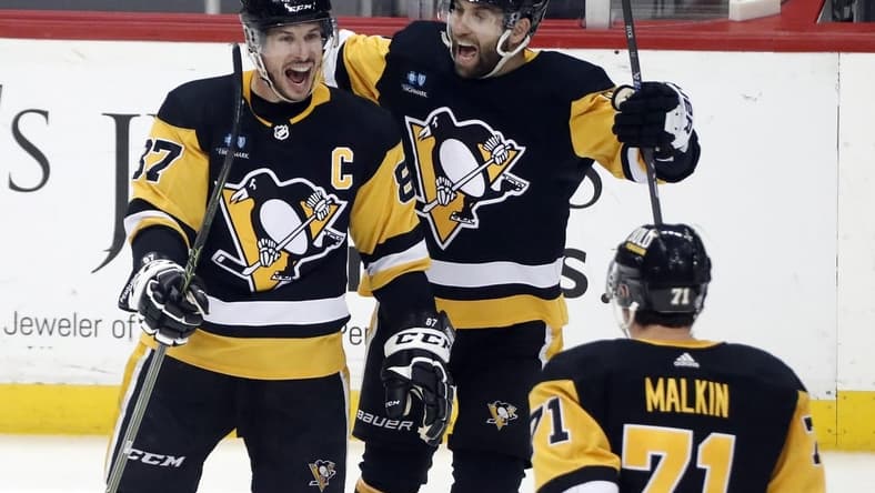 Mar 7, 2023; Pittsburgh, Pennsylvania, USA; Pittsburgh Penguins center Sidney Crosby (87) reacts with left wing Jason Zucker (16) and center Evgeni Malkin (71) after scoring the game winning power play goal in overtime against the Columbus Blue Jackets at PPG Paints Arena. Pittsburgh won 5-4 in overtime. Mandatory Credit: Charles LeClaire-USA TODAY Sports