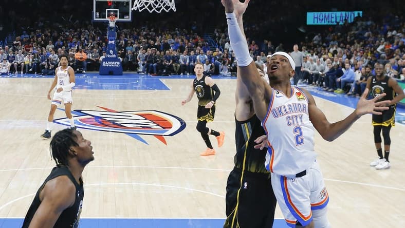Mar 7, 2023; Oklahoma City, Oklahoma, USA; Oklahoma City Thunder guard Shai Gilgeous-Alexander (2) goes to the basket in front of Golden State Warriors guard Klay Thompson (11) during the first half at Paycom Center. Oklahoma City won 137-128. Mandatory Credit: Alonzo Adams-USA TODAY Sports