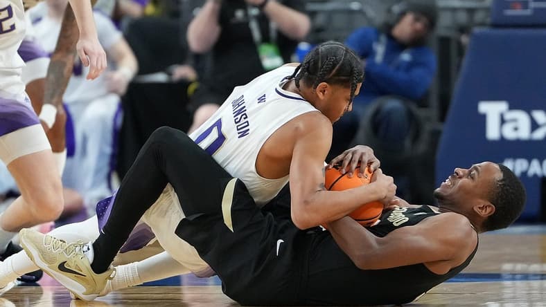 Mar 8, 2023; Las Vegas, NV, USA; Washington Huskies guard Koren Johnson (0) battles Colorado Buffaloes guard Jalen Gabbidon (3) for control of the ball during the first half at T-Mobile Arena. Mandatory Credit: Stephen R. Sylvanie-USA TODAY Sports